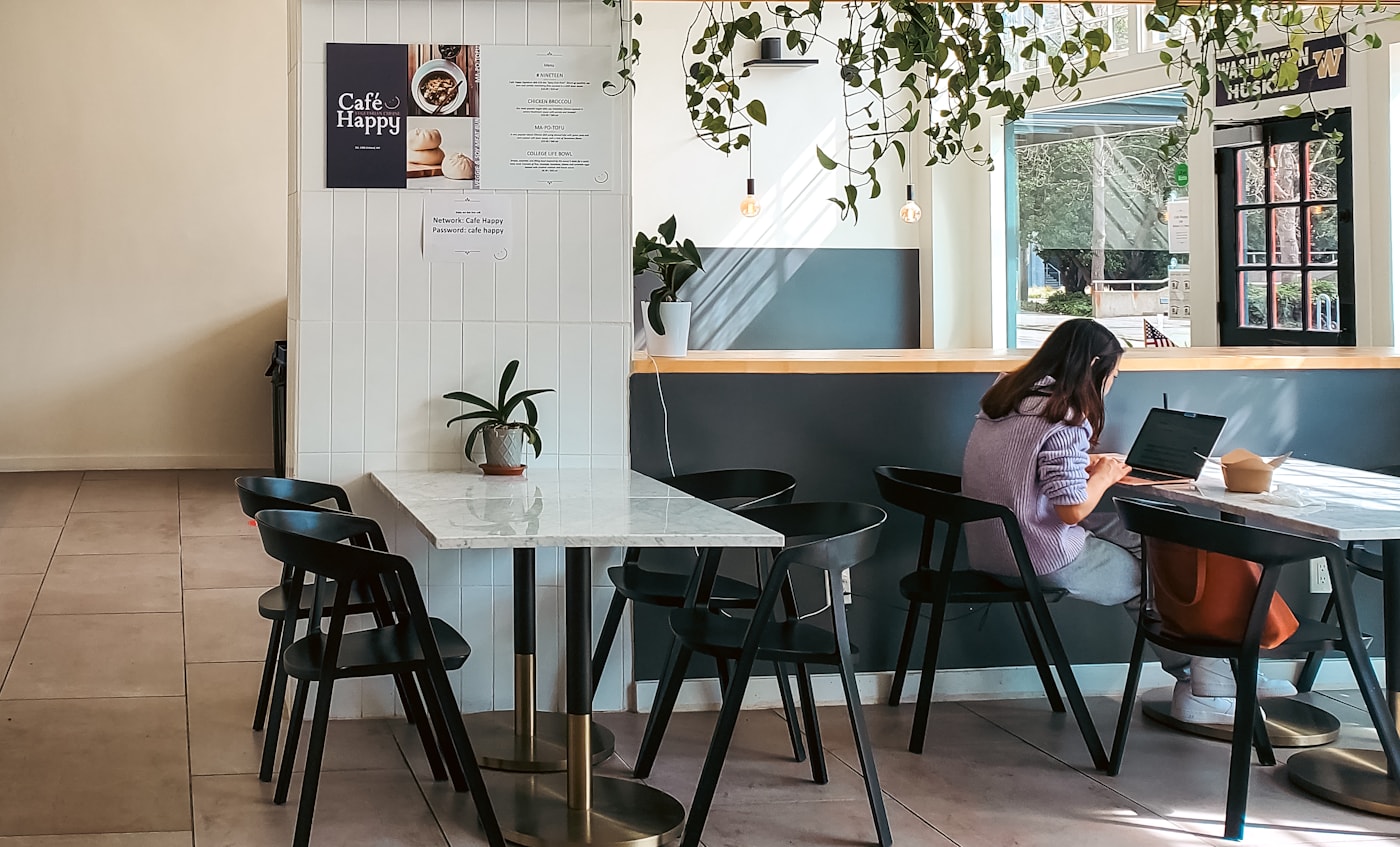 Guest using Wi-Fi at a cafe table with a laptop